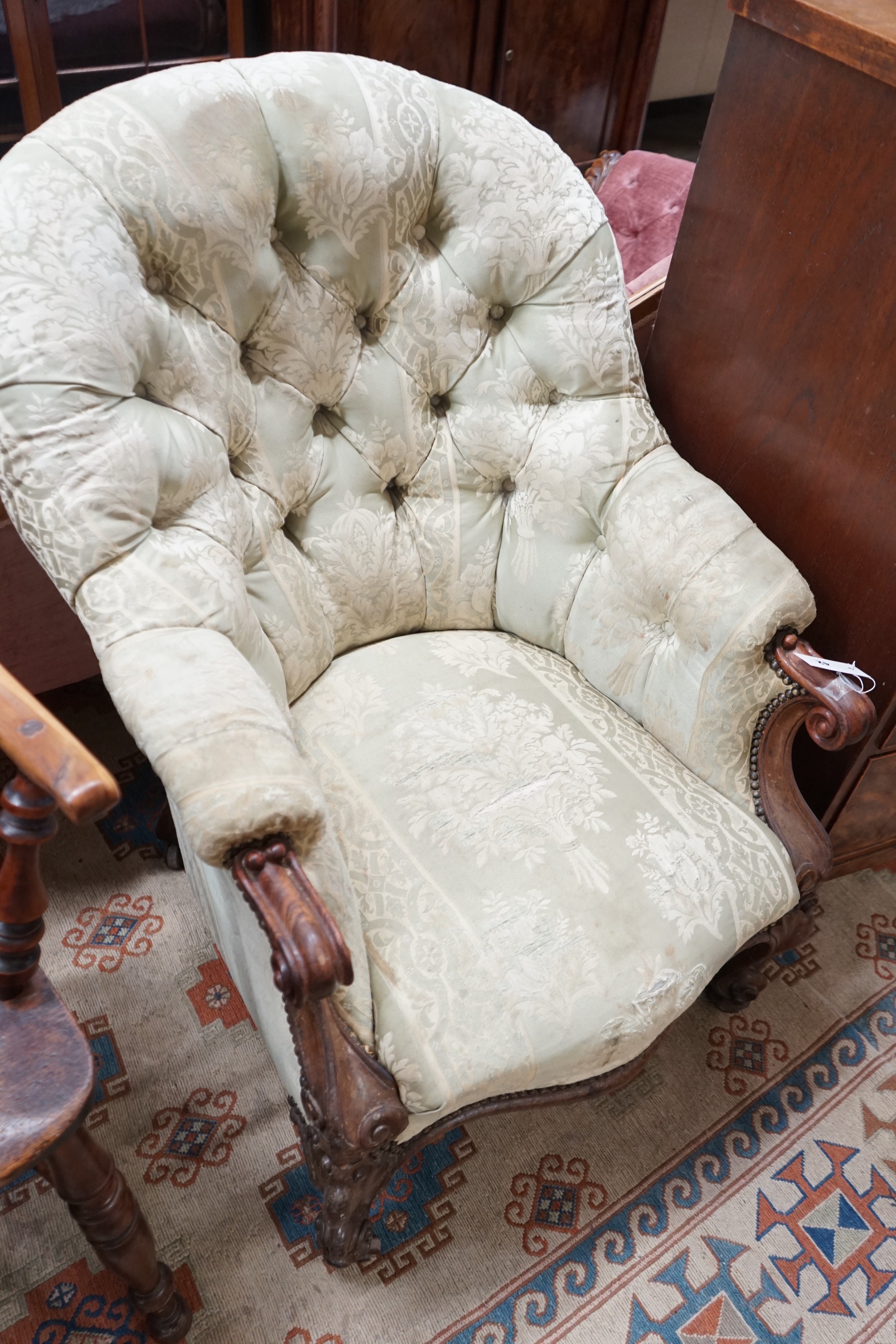 A Victorian rosewood upholstered spoon back armchair, width 66cm, depth 80cm, height 98cm